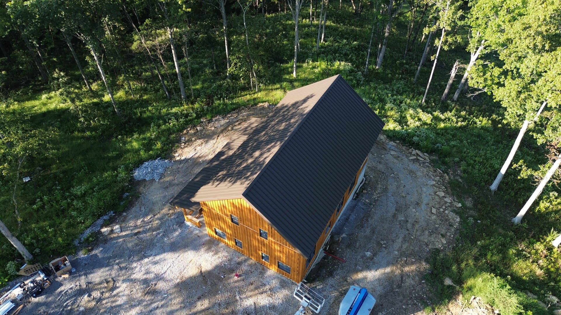 Aerial side view of Cabin Two with brown snap-lock metal roofing in Pleasureville, Kentucky.