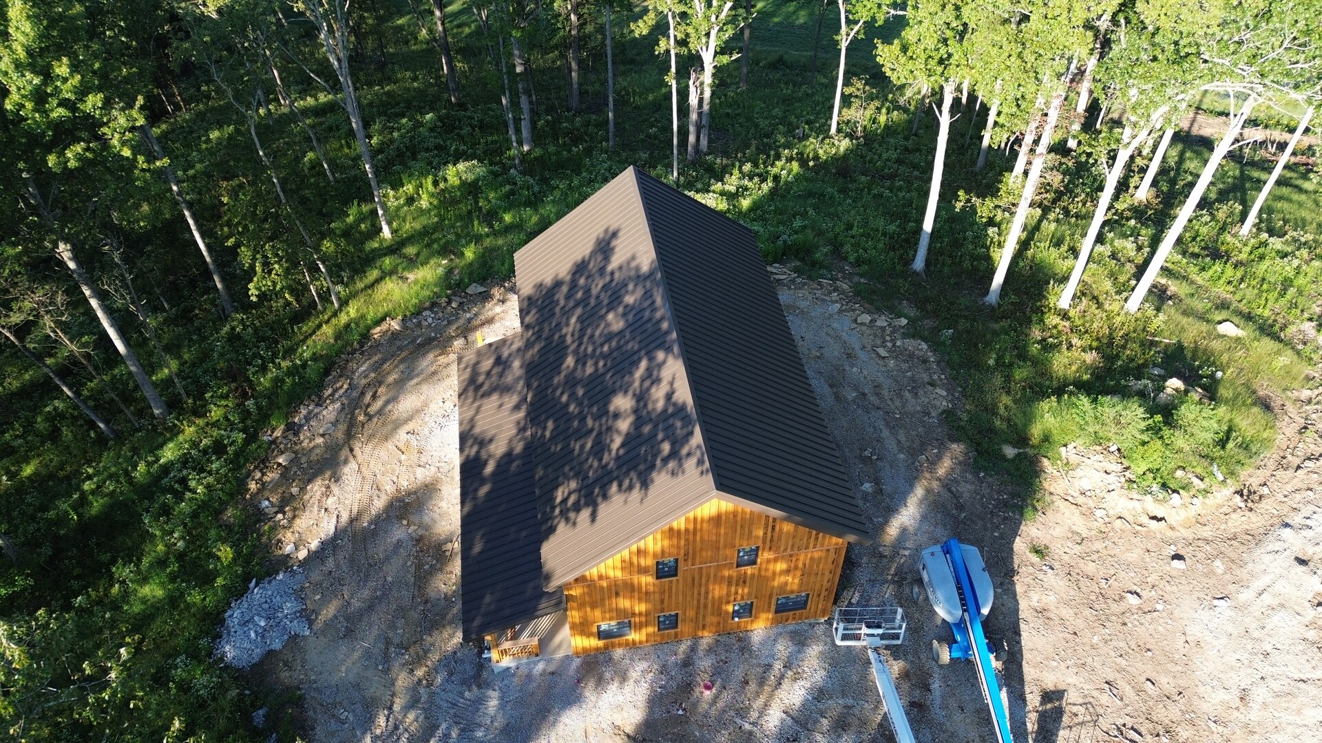 Aerial front view of Cabin Two with brown snap-lock metal roofing in Pleasureville, Kentucky.
