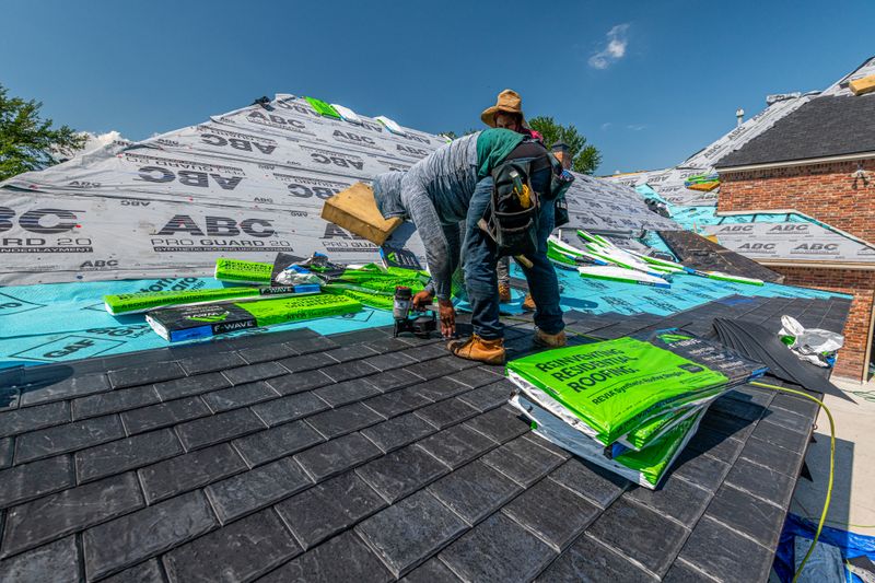 Residential roof installation on a brick house (placeholder stock photo)