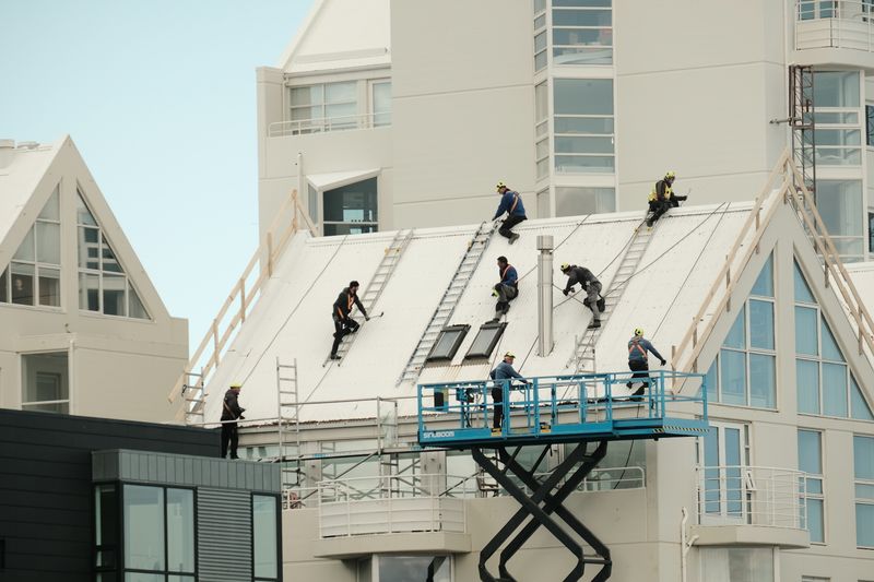 Roofing workers repairing a roof (placeholder stock photo)